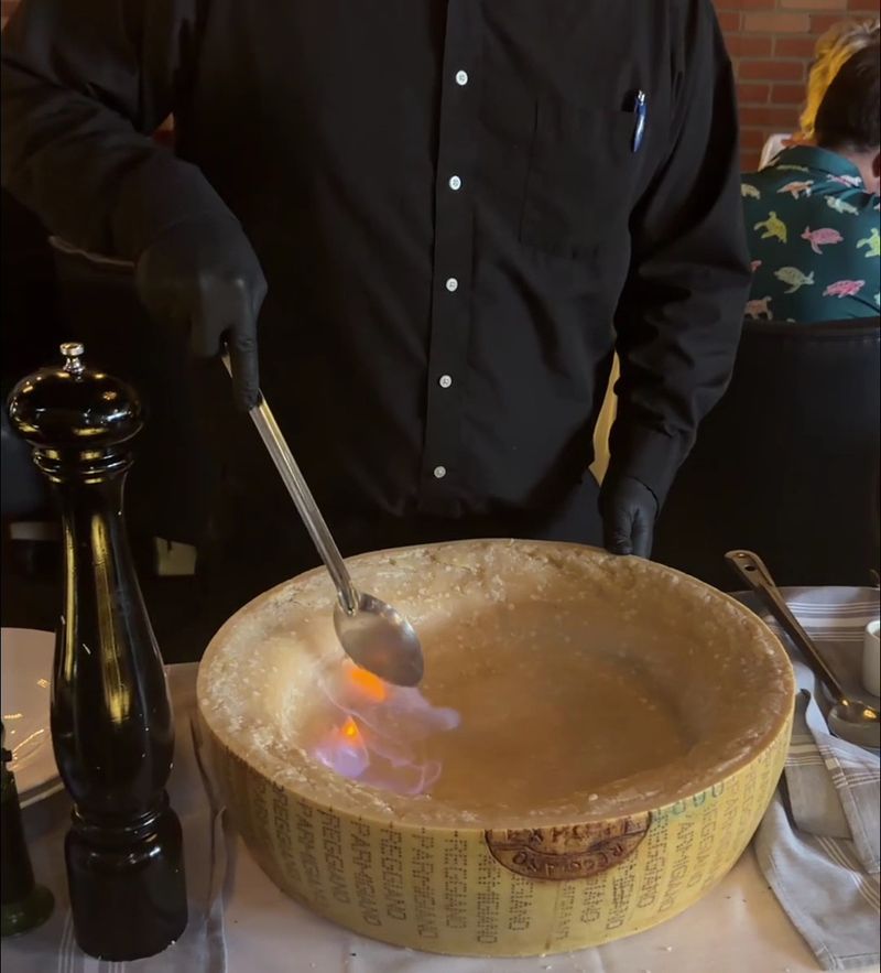 Yes, They Really Set A Giant Cheese Wheel On Fire At Your Table Yes, They Really Set A Giant Cheese Wheel On Fire At Your Table